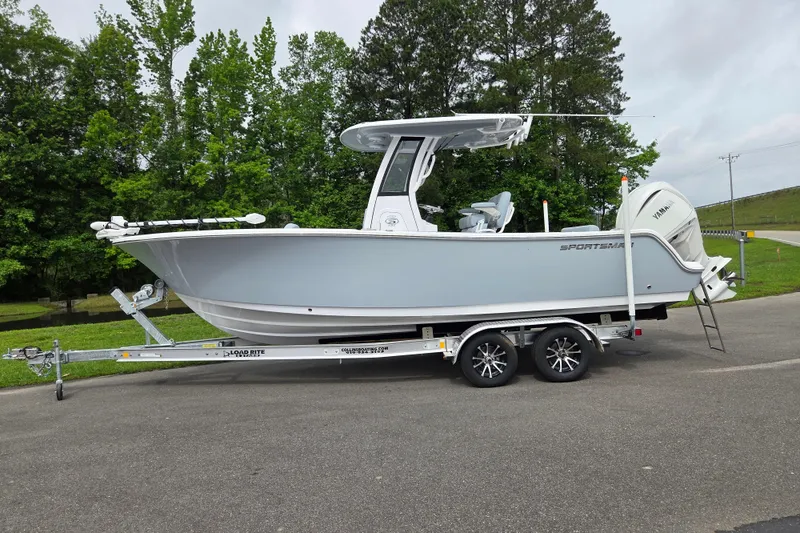 The Image of 2026 Sportsman Open 232 Center Console boat on trailer, parked outdoors. - 0