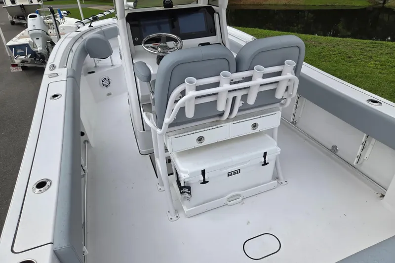 Slide: The Image of 2026 Sportsman Open 232 Center Console boat interior with seating and storage. - 11
