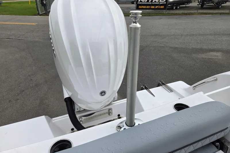 Slide: The Image of 2026 Sportsman Open 232 Center Console boat with sleek white motor and wet seating area. - 13