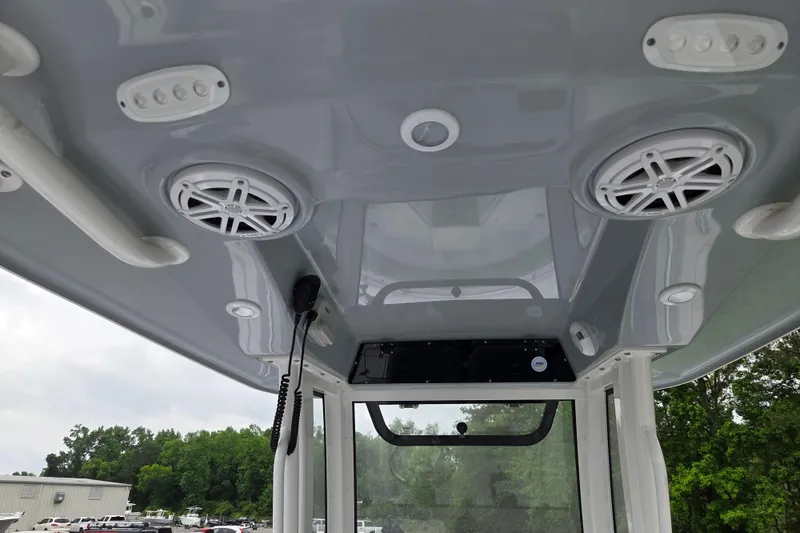 Slide: The Image of 2026 Sportsman Open 232 Center Console boat interior with speakers and controls. - 15