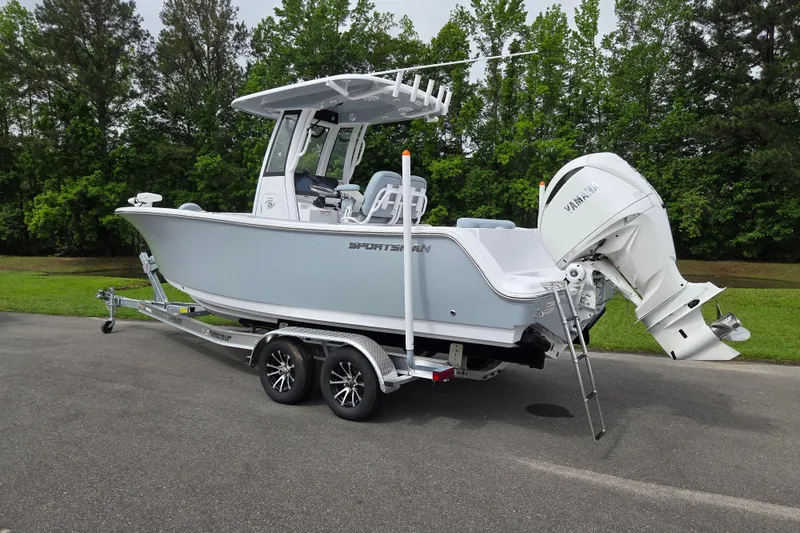 Slide: The Image of 2026 Sportsman Open 232 Center Console boat on trailer, parked outdoors. - 2