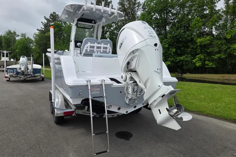 Slide: The Image of 2026 Sportsman Open 232 Center Console boat with Yamaha outboard motor on trailer. - 3