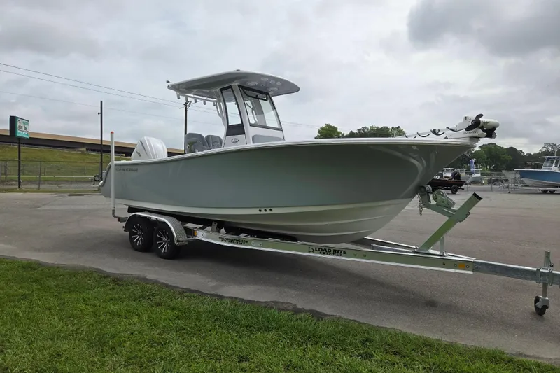 Slide: The Image of 2026 Sportsman Open 232 Center Console boat on trailer, parked outdoors. - 7