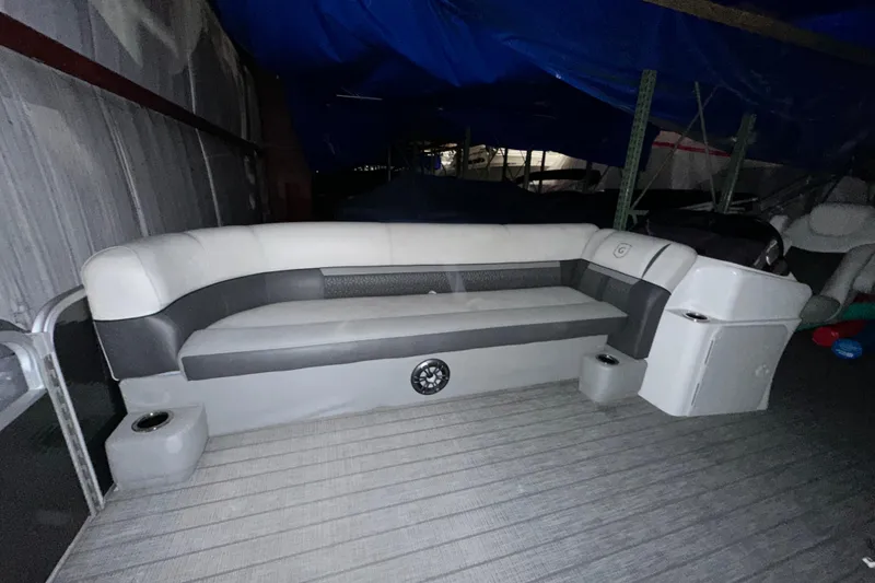 Slide: The Image of 2019 Sweetwater 2286 SFL boat interior with cushioned seating and storage compartments. - 3