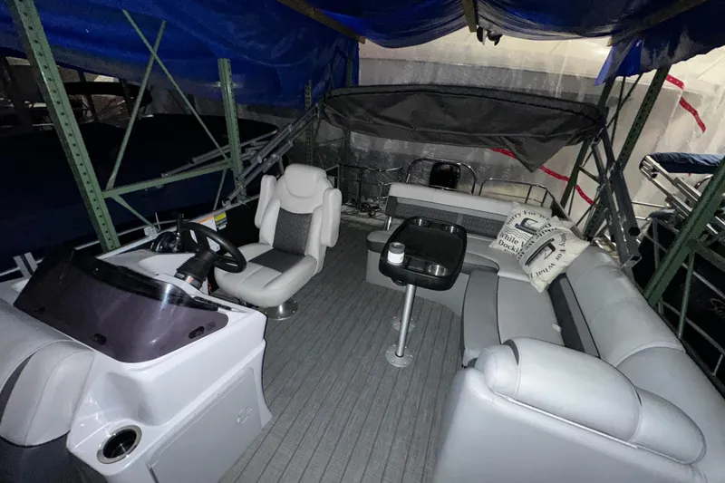 Slide: The Image of 2019 Sweetwater 2286 SFL boat interior with seating and steering console. - 4