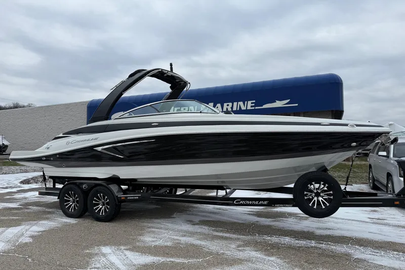 The Image of 2026 Crownline 288 SS boat on trailer, displayed outdoors at a marine dealership. - 0
