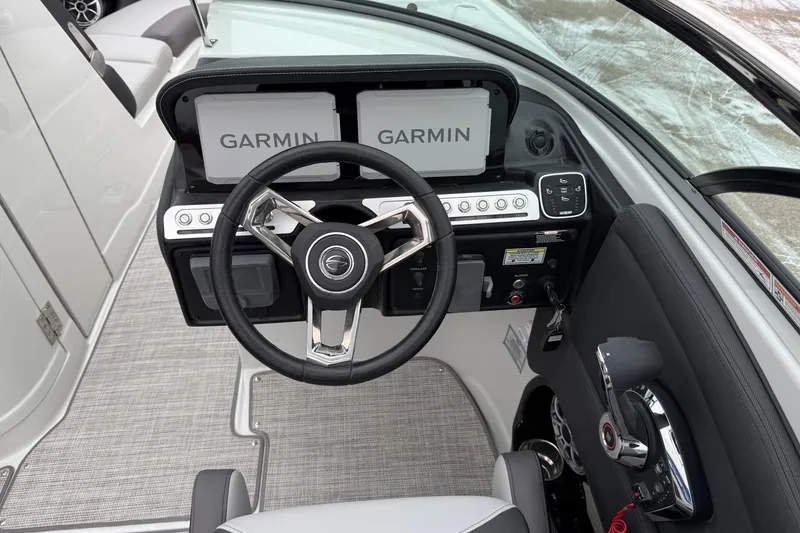 Slide: The Image of 2026 Crownline 288 SS boat helm with Garmin displays and modern steering wheel. - 11