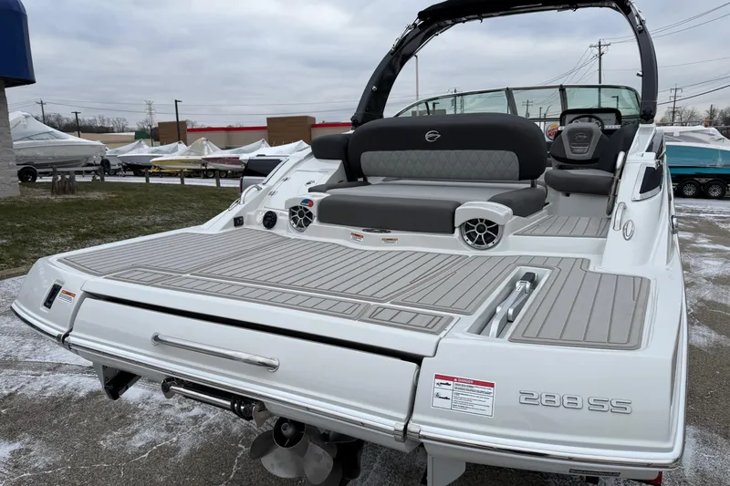 Slide: The Image of 2026 Crownline 288 SS boat with spacious deck and seating, displayed outdoors. - 13
