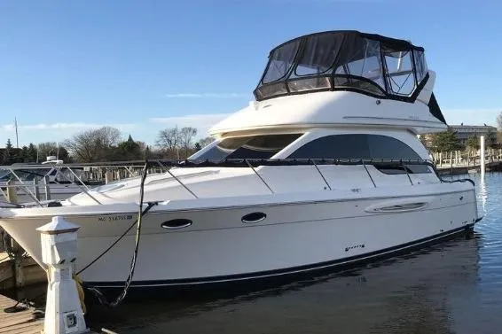 The Image of 2003 Meridian 381 Sedan yacht docked at marina under clear blue sky. - 0