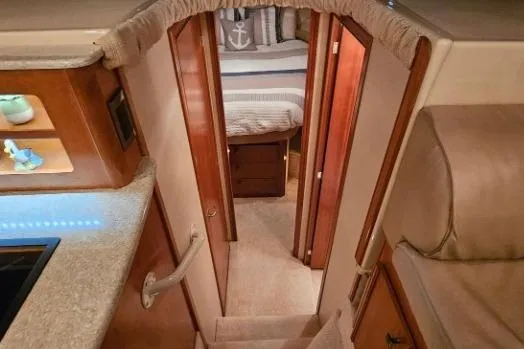 Slide: The Image of Interior of 2003 Meridian 381 Sedan yacht, featuring cozy cabin and wooden finishes. - 13