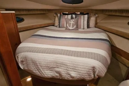 Slide: The Image of Cozy bedroom in 2003 Meridian 381 Sedan yacht with nautical-themed bedding. - 14