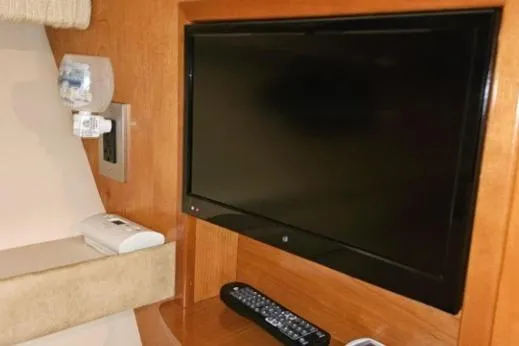 Slide: The Image of Flat-screen TV and remote in 2003 Meridian 381 Sedan interior. - 15