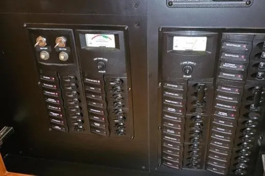 Slide: The Image of Electrical panel on a 2003 Meridian 381 Sedan boat, featuring switches and gauges. - 18