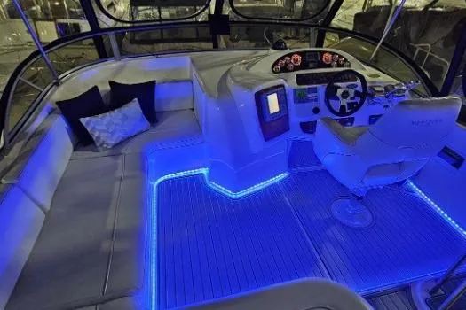 Slide: The Image of Luxurious 2003 Meridian 381 Sedan yacht interior with blue LED lighting and plush seating. - 20