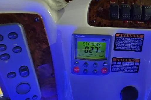 Slide: The Image of Control panel of a 2003 Meridian 381 Sedan boat with digital display and warning labels. - 25