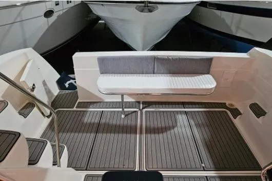 Slide: The Image of 2003 Meridian 381 Sedan boat deck with seating and non-slip flooring. - 3