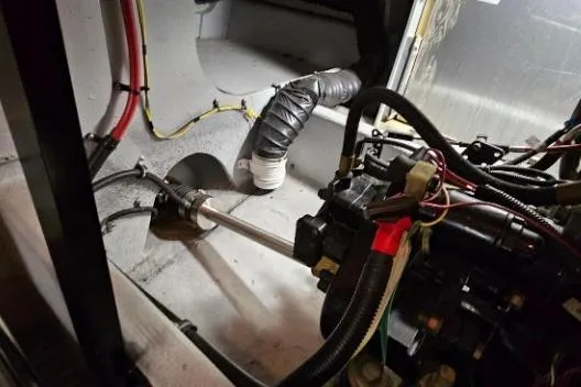 Slide: The Image of Engine compartment of a 2003 Meridian 381 Sedan boat, showing mechanical components and wiring. - 33