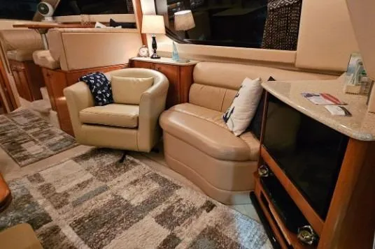 Slide: The Image of Luxurious interior of a 2003 Meridian 381 Sedan yacht with cozy seating and modern decor. - 5
