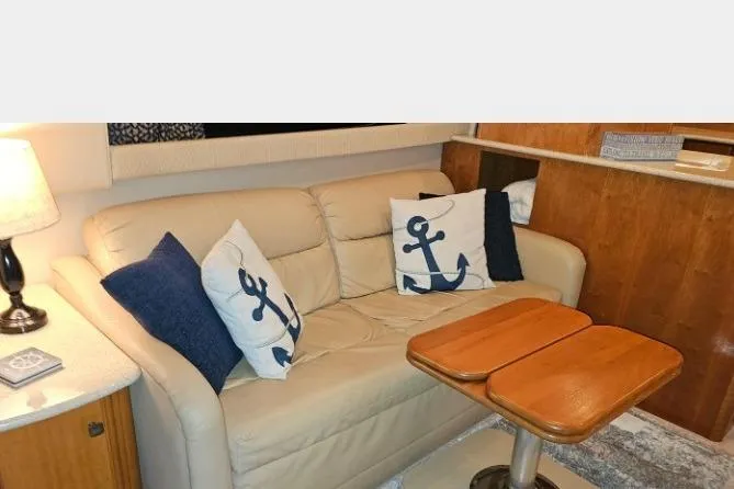 Slide: The Image of Interior of 2003 Meridian 381 Sedan with beige sofa and nautical-themed pillows. - 6