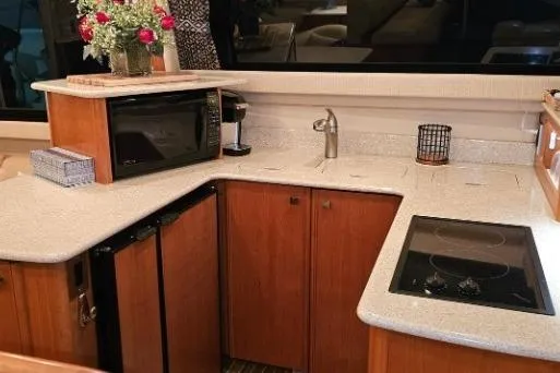 Slide: The Image of Luxurious 2003 Meridian 381 Sedan yacht kitchen with modern appliances and elegant wood cabinetry. - 8