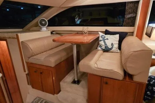 Slide: The Image of 2003 Meridian 381 Sedan interior with cozy dining area and nautical-themed decor. - 9