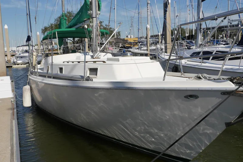 Slide: The Image of 1973 Gulfstar 41 Ketch CC sailboat docked at marina, featuring green sails. - 0