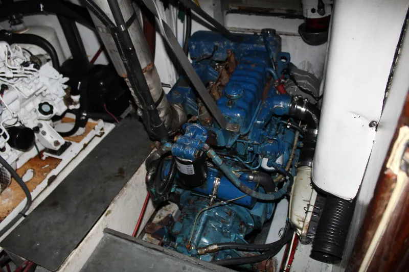 Slide: The Image of 1973 Gulfstar 41 Ketch CC engine compartment with blue marine engine. - 15