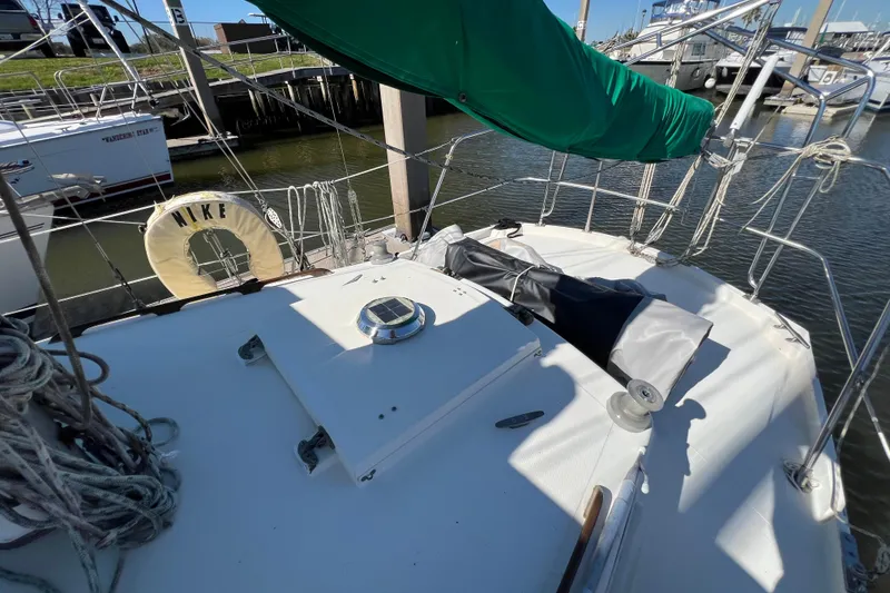 Slide: The Image of 1973 Gulfstar 41 Ketch CC sailboat deck with green cover and life preserver. - 25