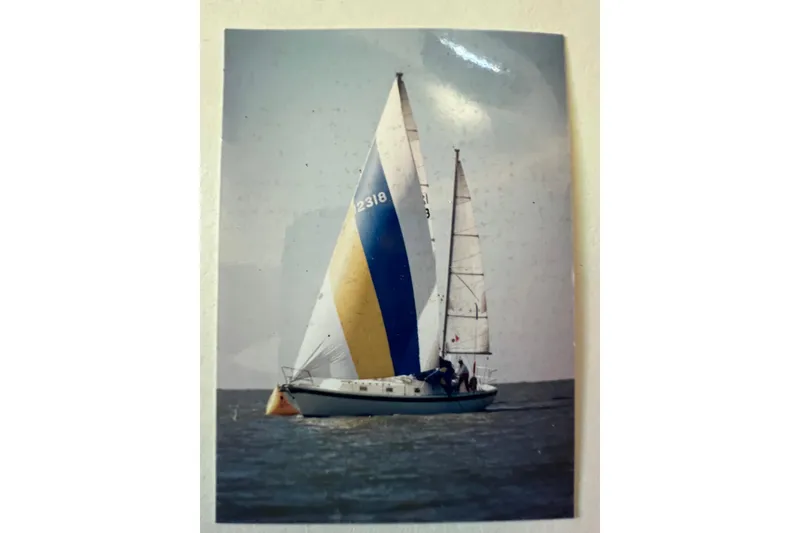 Slide: The Image of 1973 Gulfstar 41 Ketch CC sailing on open water with colorful sails. - 26