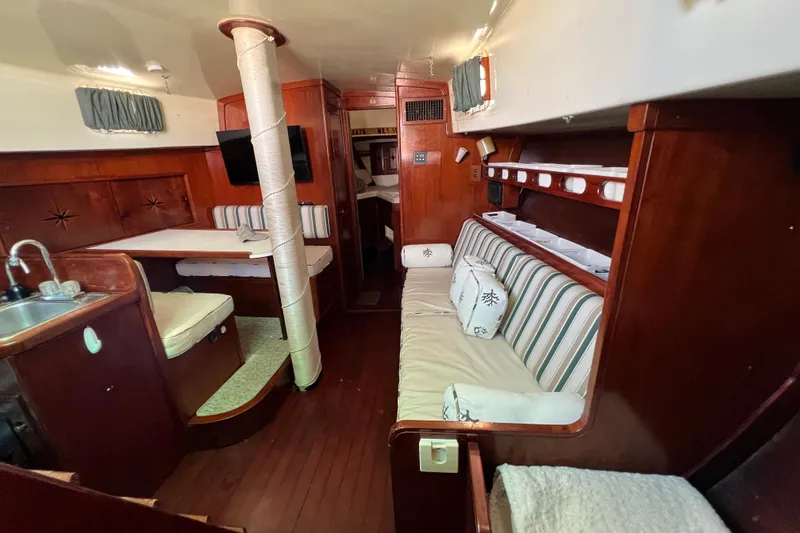 Slide: The Image of Interior of 1973 Gulfstar 41 Ketch CC, featuring wood paneling and cozy seating. - 27