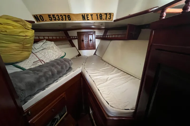 Slide: The Image of Cozy cabin interior of 1973 Gulfstar 41 Ketch CC with wooden furnishings and bedding. - 31