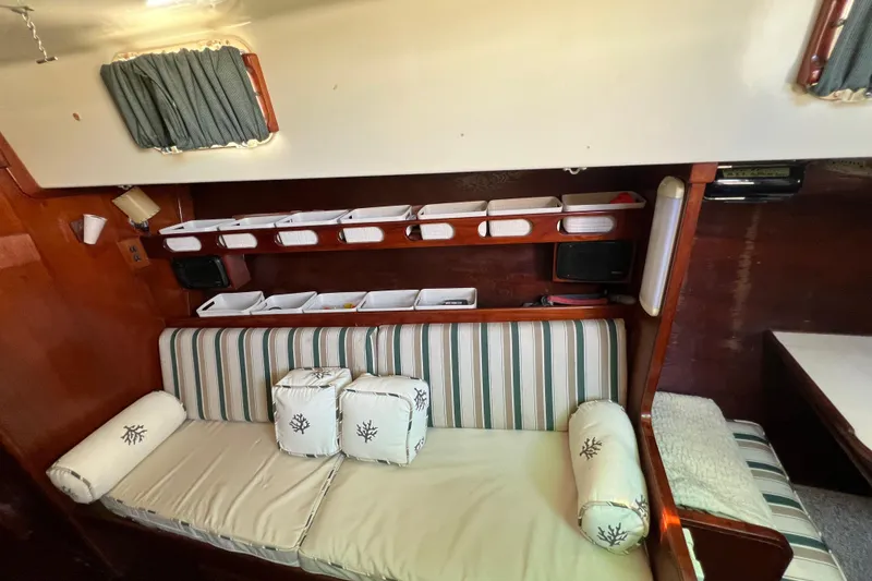 Slide: The Image of Interior of 1973 Gulfstar 41 Ketch CC with striped seating and storage shelves. - 41