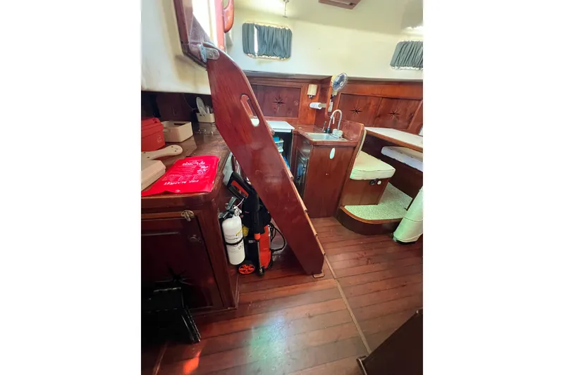 Slide: The Image of Interior of 1973 Gulfstar 41 Ketch CC with wooden cabinetry and seating area. - 45