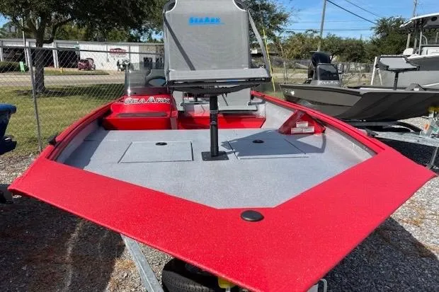 Slide: The Image of 2026 SeaArk Shadow 18 boat with red deck and seating. - 3