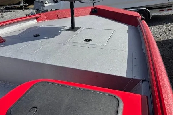 Slide: The Image of Red 2026 SeaArk Shadow 18 boat deck with storage compartments and fishing seat mount. - 4