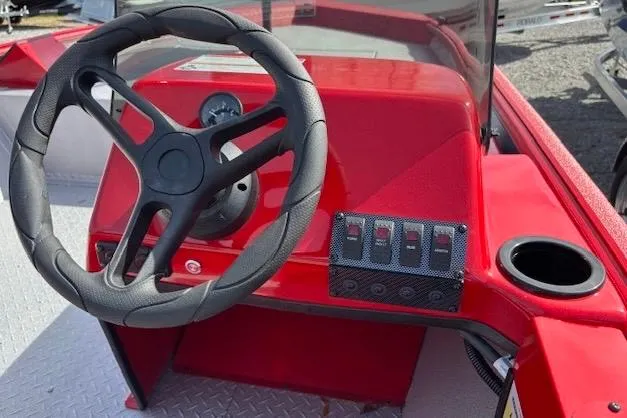 Slide: The Image of 2026 SeaArk Shadow 18 boat dashboard with steering wheel and control panel. - 5