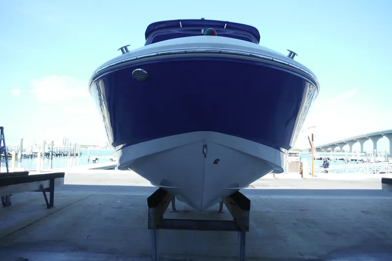 Slide: The Image of 2018 Chaparral 21 H2O Sport OB boat on a dock, front view. - 12
