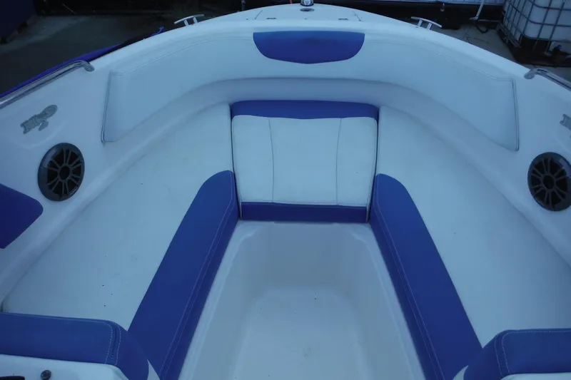 Slide: The Image of Interior seating of 2018 Chaparral 21 H2O Sport OB boat, featuring blue and white upholstery. - 18