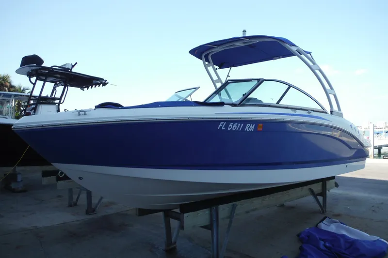 Slide: The Image of 2018 Chaparral 21 H2O Sport OB boat with blue hull on display. - 37