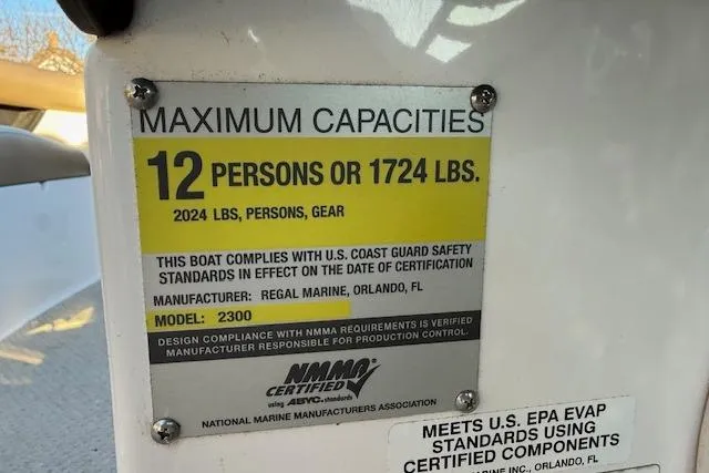 Slide: The Image of 2010 Regal 2300 Bowrider interior with beige seating and carpeted flooring. - 11