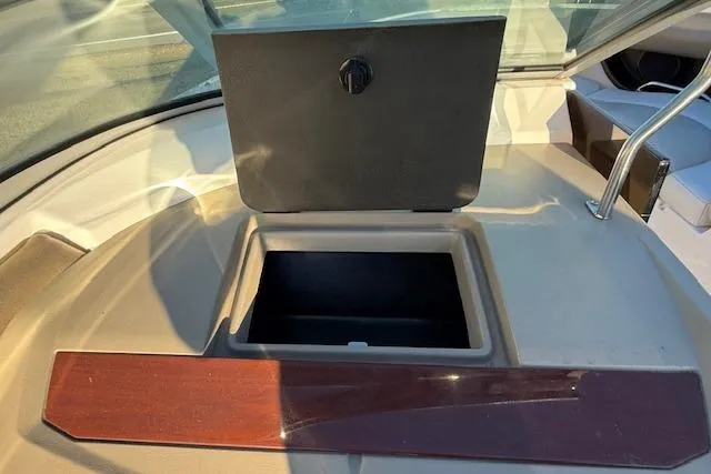 Slide: The Image of 2010 Regal 2300 Bowrider boat interior with cushioned seating and cup holders. - 13