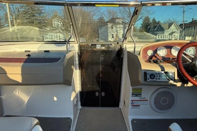 Slide: The Image of 2010 Regal 2300 Bowrider interior with beige seating and carpeted floor. - 14