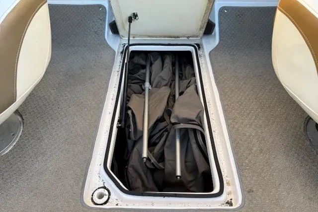Slide: The Image of Interior seating of a 2010 Regal 2300 Bowrider boat, featuring beige and tan upholstery. - 15