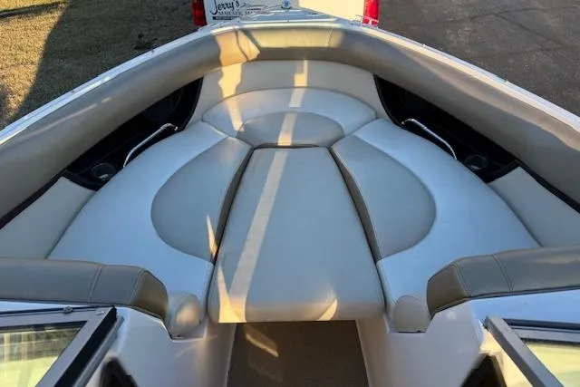 Slide: The Image of 2010 Regal 2300 Bowrider interior seating with beige upholstery and sleek design. - 17