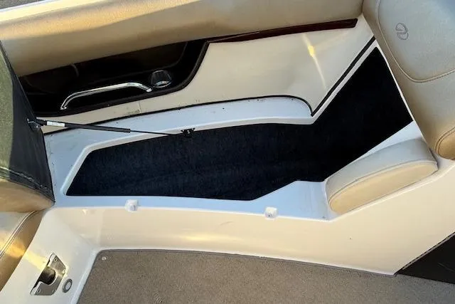 Slide: The Image of 2010 Regal 2300 Bowrider storage compartment with water skis and accessories. - 20