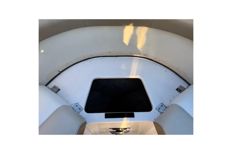 Slide: The Image of 2010 Regal 2300 Bowrider boat interior with open storage compartments. - 22