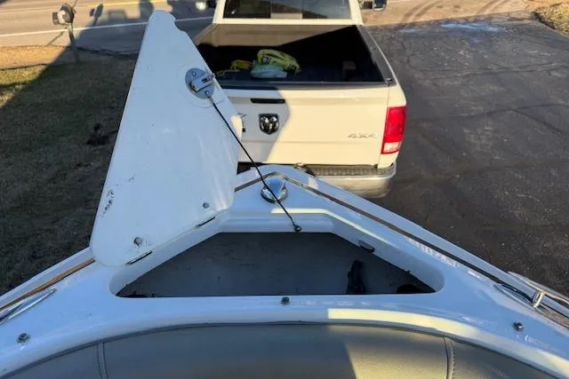 Slide: The Image of 2010 Regal 2300 Bowrider boat engine compartment with open hatch, showcasing engine details. - 23