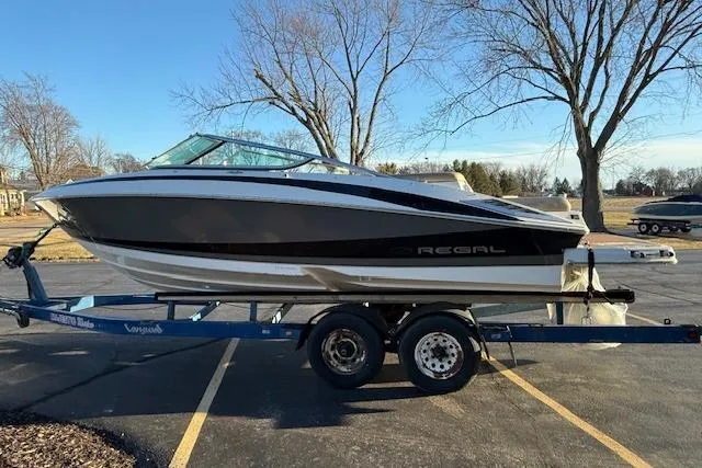 Slide: The Image of 2010 Regal 2300 Bowrider boat on trailer, rear view with propeller visible. - 3