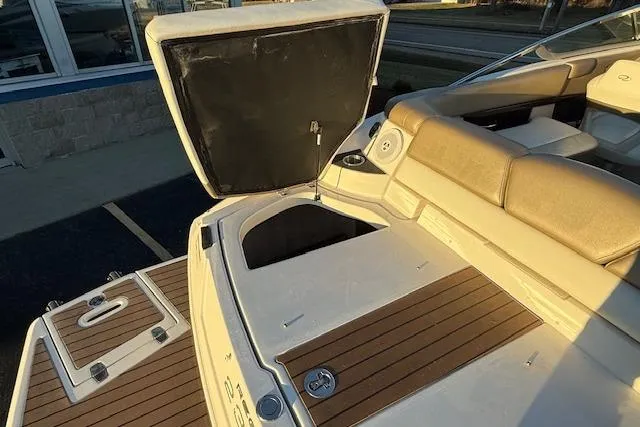 Slide: The Image of 2010 Regal 2300 Bowrider boat on trailer, covered, parked outdoors. - 34