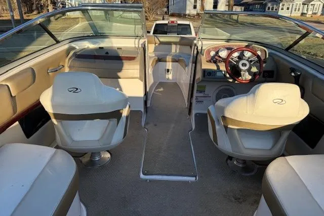 Slide: The Image of 2010 Regal 2300 Bowrider interior with beige seating and steering console. - 5